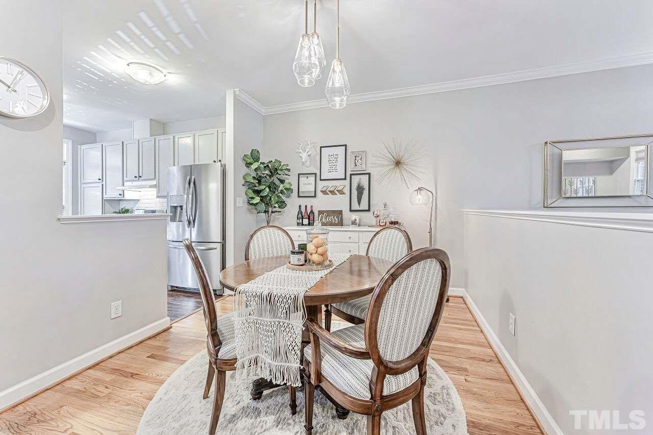 125 Fenner Lane Raleigh, NC 27603 - Photo 11 of 30 a dining room with furniture and chandelier