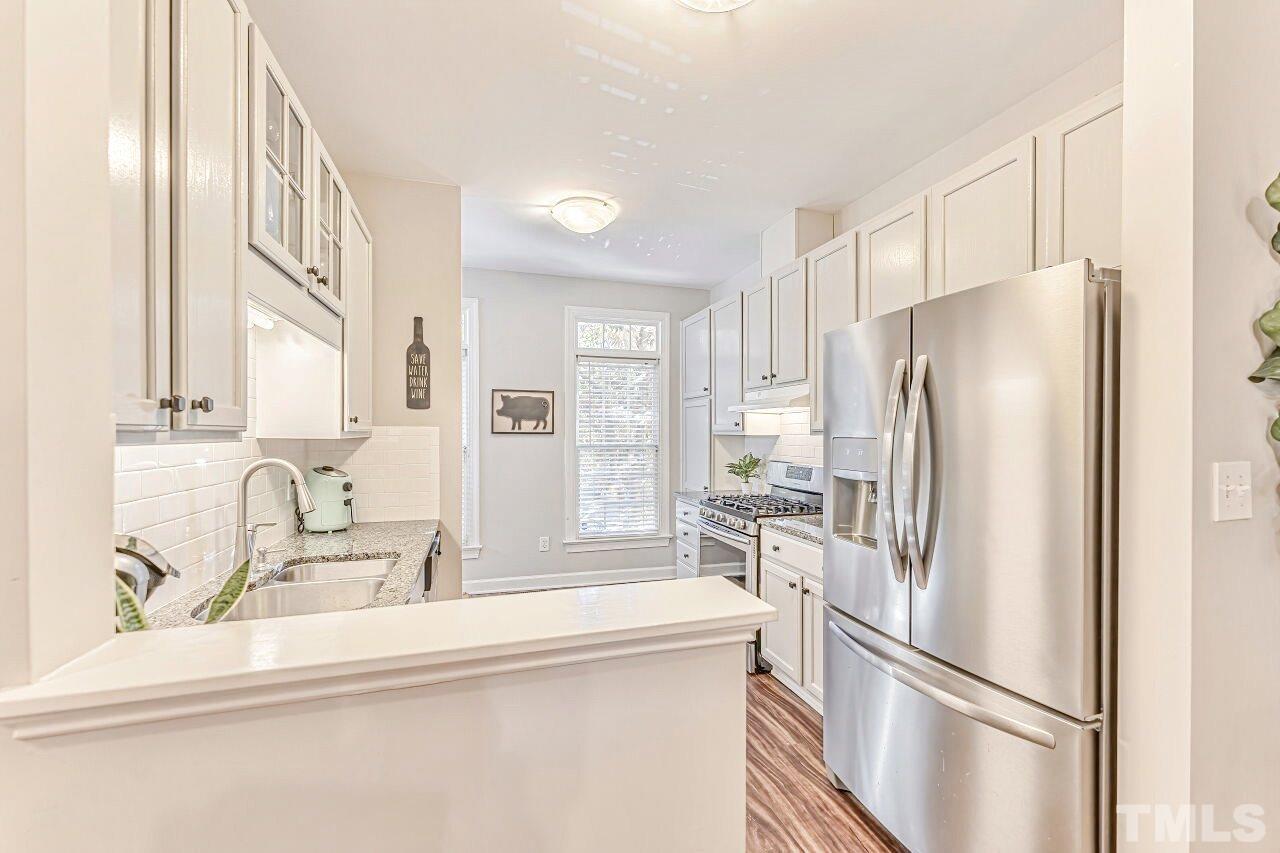 125 Fenner Lane Raleigh, NC 27603 - Photo 15 of 30 a kitchen with stainless steel appliances a refrigerator and a sink