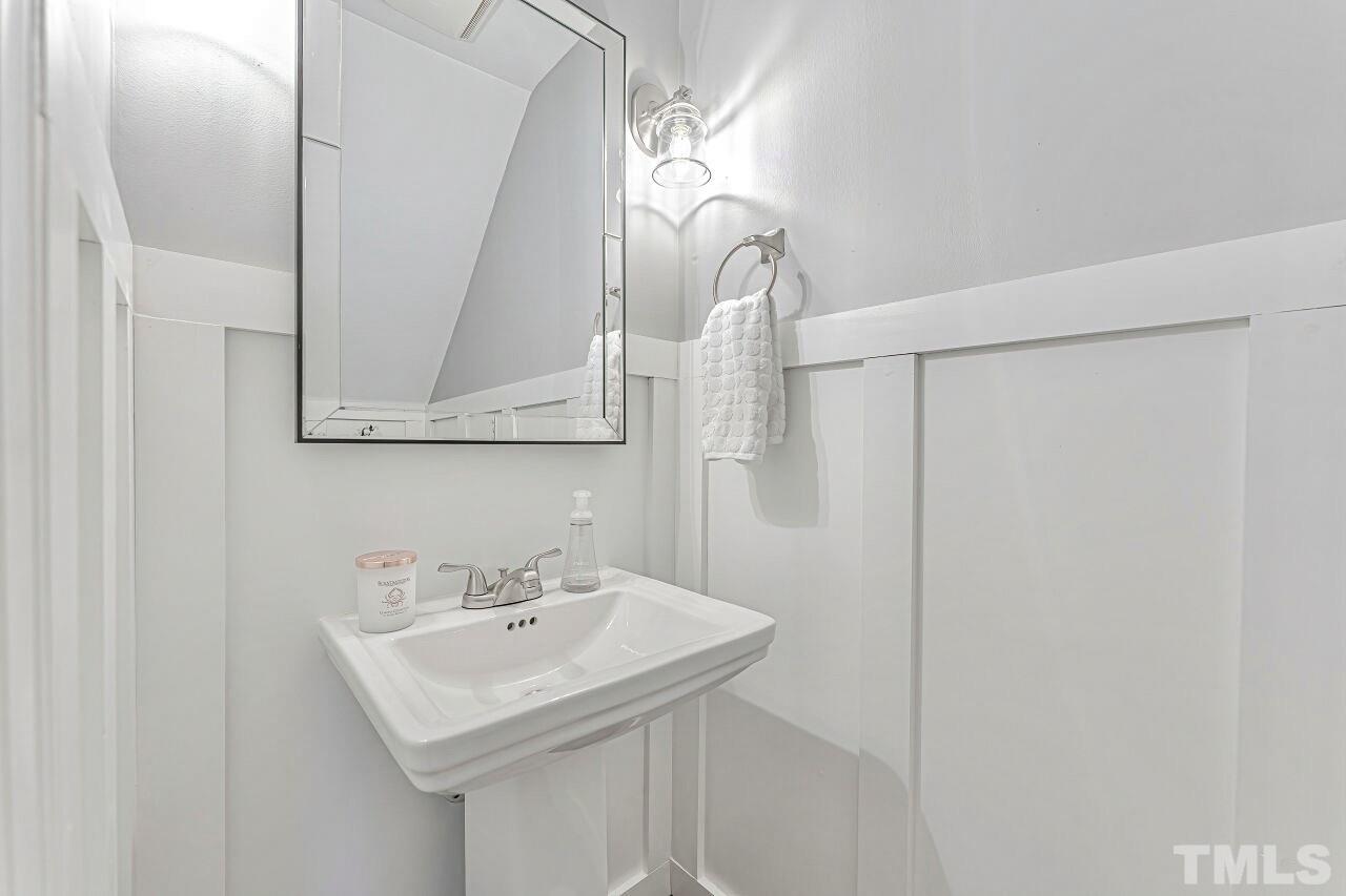 125 Fenner Lane Raleigh, NC 27603 - Photo 16 of 30 a bathroom with a sink a mirror and a shower