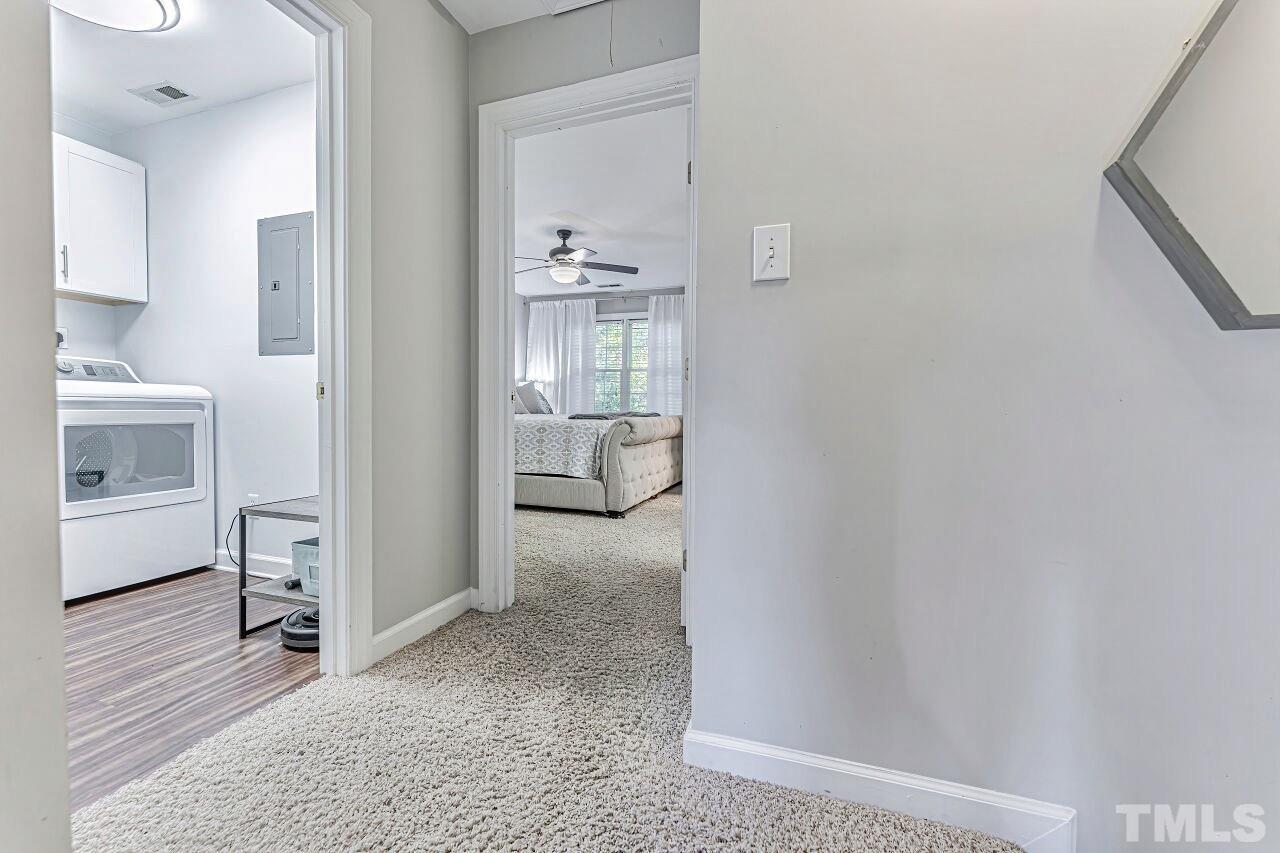 125 Fenner Lane Raleigh, NC 27603 - Photo 19 of 30 a view of a hallway with bathroom and wooden floor