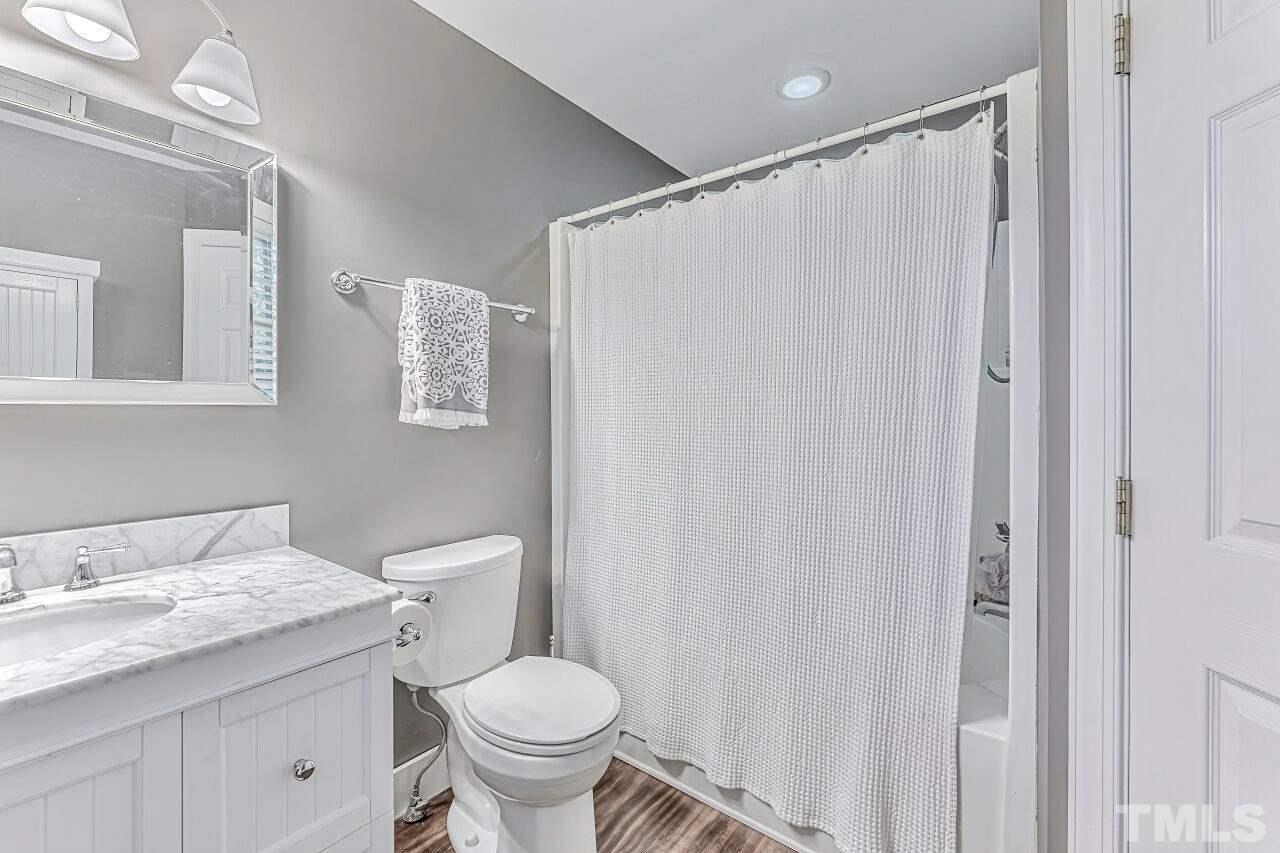 125 Fenner Lane Raleigh, NC 27603 - Photo 22 of 30 a bathroom with a granite countertop sink toilet and shower