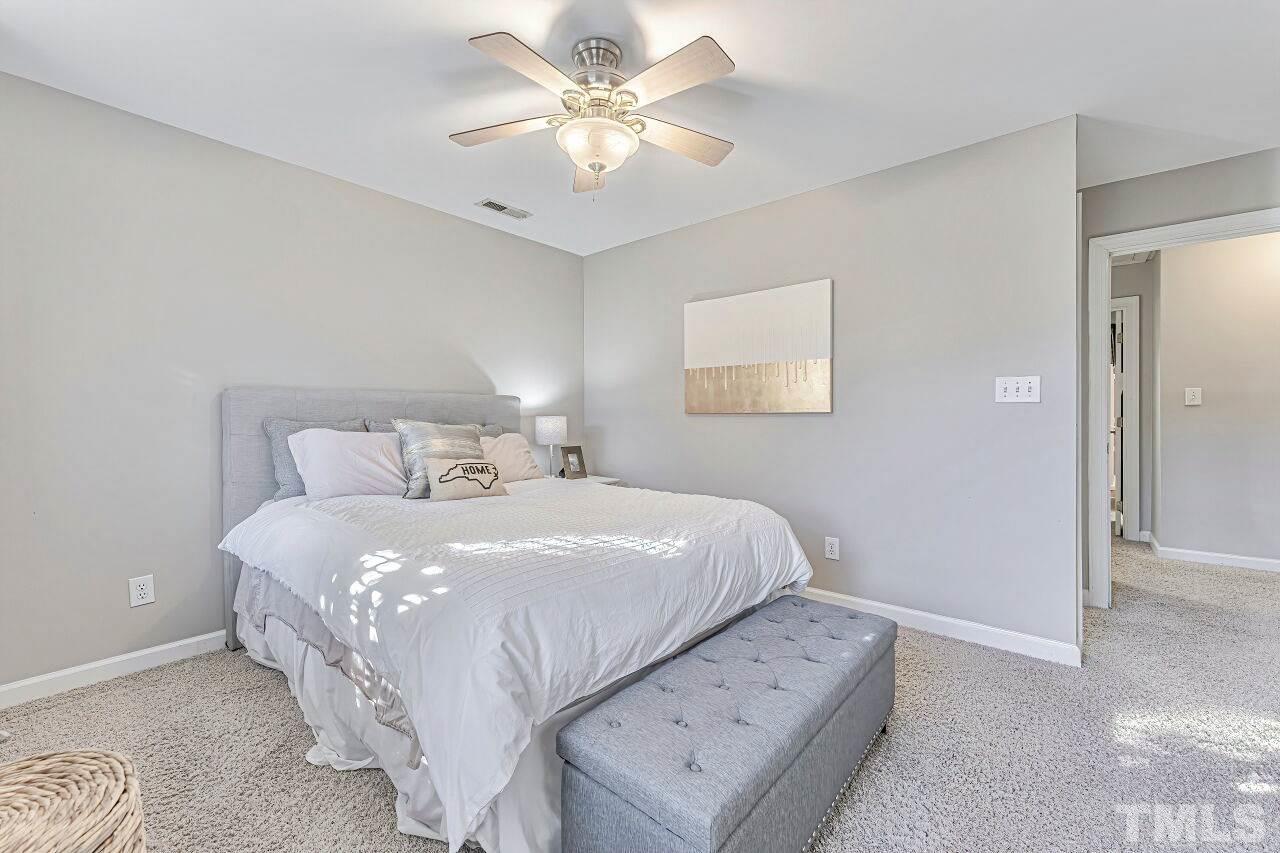 125 Fenner Lane Raleigh, NC 27603 - Photo 24 of 30 a bedroom with a bed and a ceiling fan
