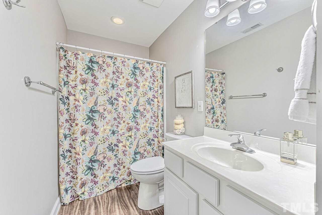 125 Fenner Lane Raleigh, NC 27603 - Photo 25 of 30 a bathroom with a sink toilet and shower