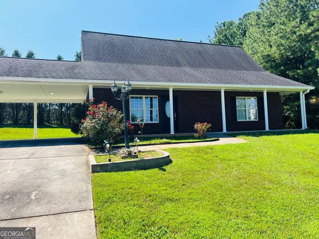 a view of a house with swimming pool and a yard