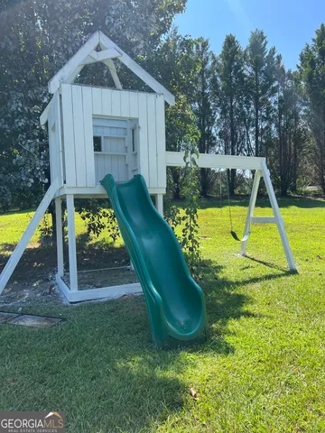 a view of a house with a swimming pool and sitting area