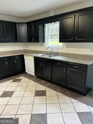 a kitchen with a cabinets and a stove top oven