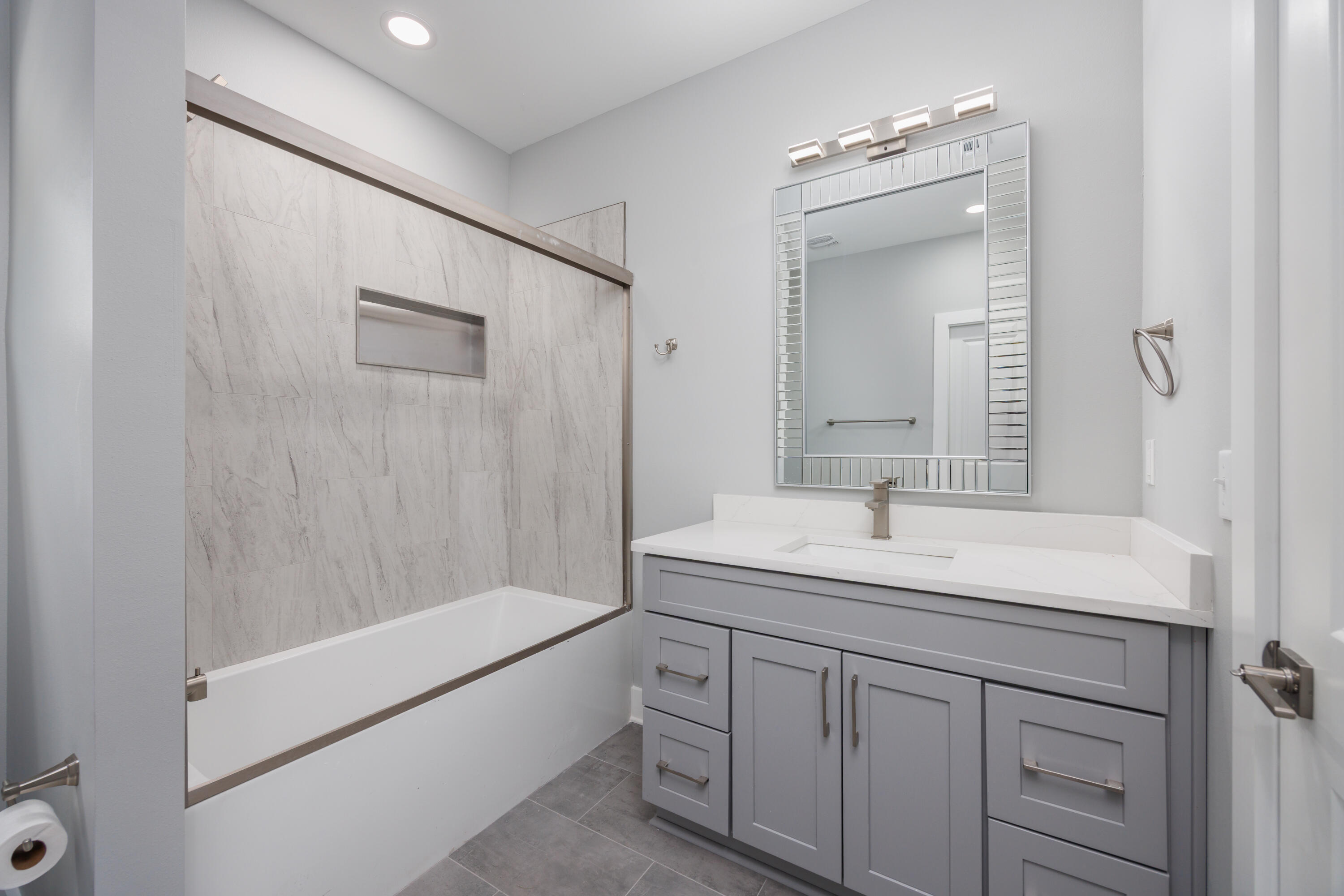 26 Shebbi Lane Freeport, FL 32439 - Photo 11 of 19 a bathroom with a sink double vanity granite tub shower and a mirror