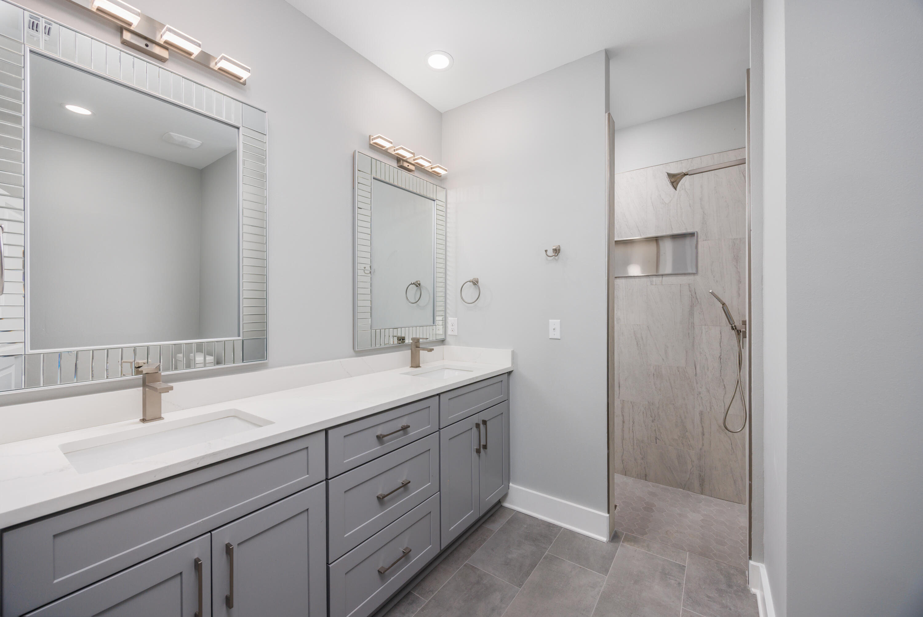 26 Shebbi Lane Freeport, FL 32439 - Photo 13 of 19 a bathroom with a double vanity sink mirror and shower