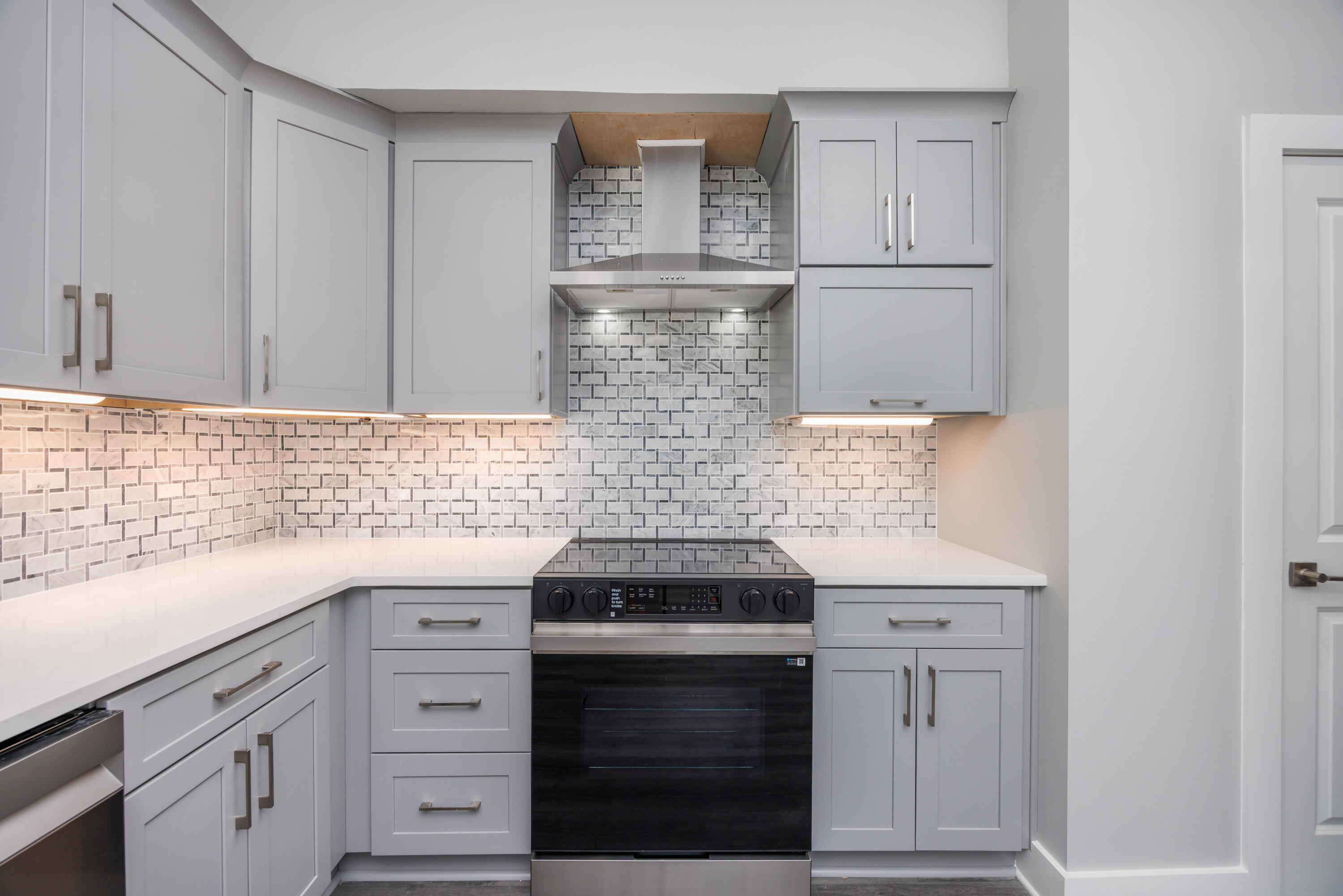 26 Shebbi Lane Freeport, FL 32439 - Photo 7 of 19 a kitchen with white cabinets and appliances
