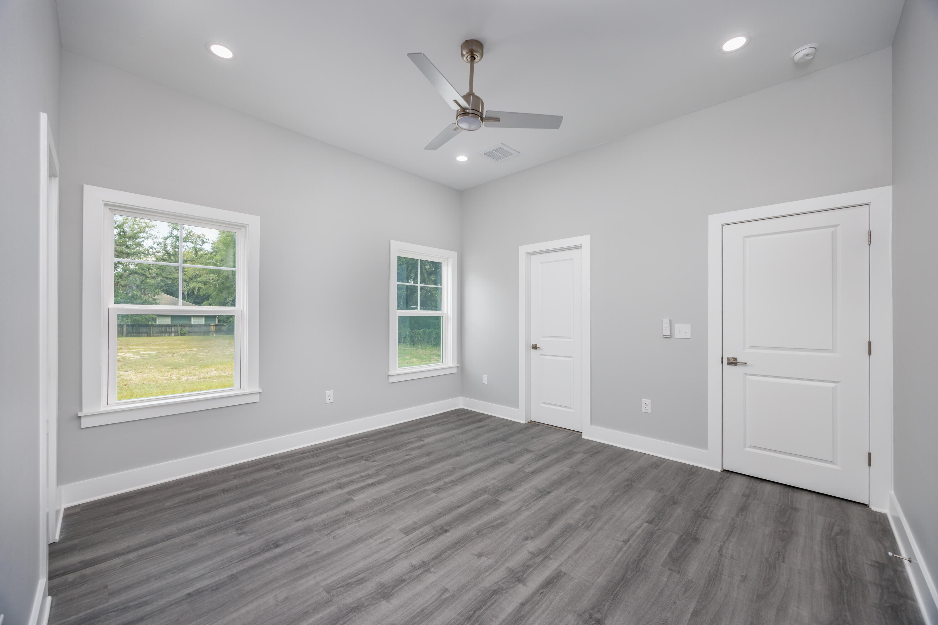 26 Shebbi Lane Freeport, FL 32439 - Photo 10 of 19 wooden floor in an empty room with a window