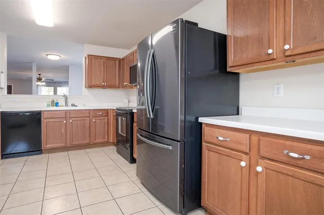a kitchen with stainless steel appliances granite countertop a refrigerator sink and cabinets