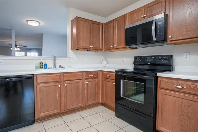 a kitchen with granite countertop cabinets stainless steel appliances and wooden cabinets