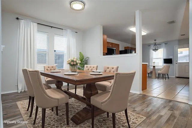 a view of a dining room with furniture and wooden floor