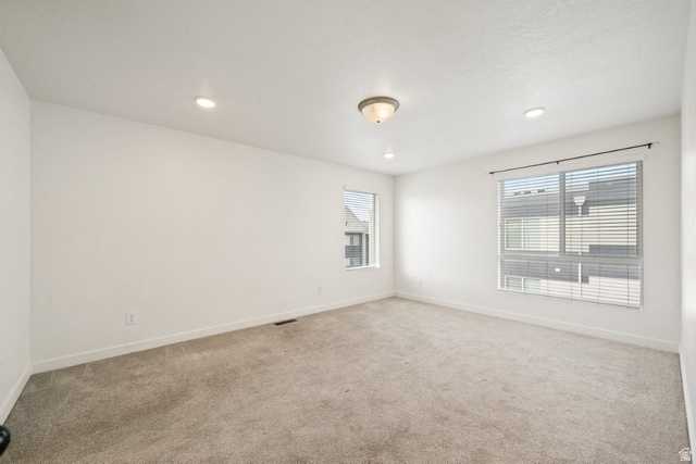 70 East Weekes Way Clearfield, UT 84015 - Photo 14 of 25 Unfurnished room featuring light carpet and recessed lighting