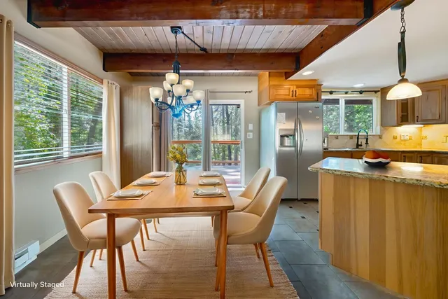 a dining room with furniture and window