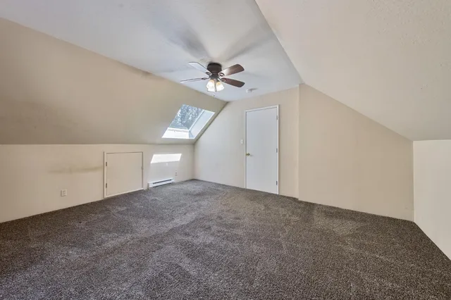 a bedroom with a bed and ceiling fan