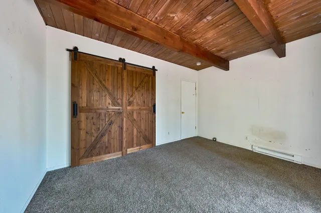 a view of a wooden deck next to a yard
