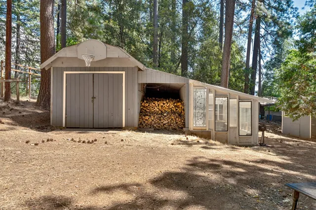 a view of a lush green field with mountains in the background