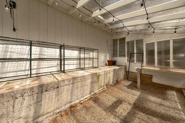 a view of a lush green field with mountains in the background