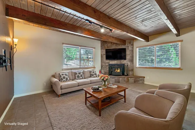 a living room with furniture a fireplace and a flat screen tv