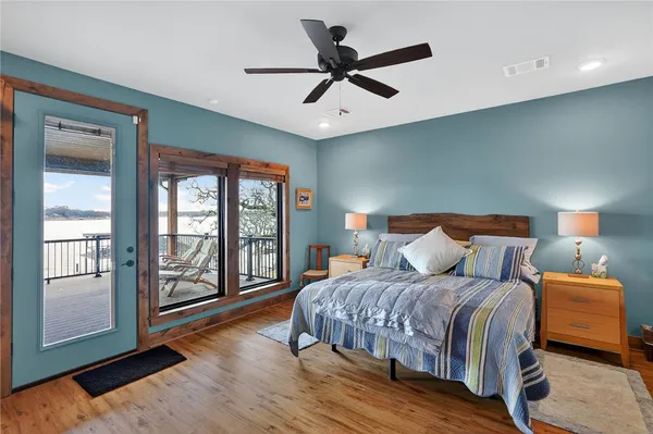 a bedroom with a bed and a large window