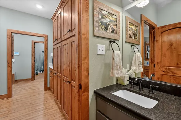 a kitchen with a stove a sink dishwasher and cabinets with wooden floor