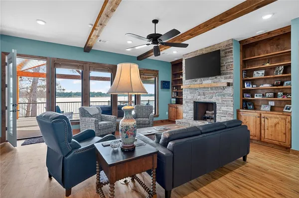 a living room with fireplace furniture and a flat screen tv