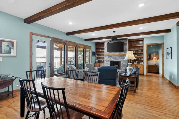 a dining room with furniture window and wooden floor