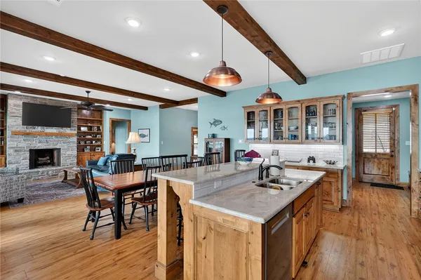a kitchen with a table chairs and wooden floor