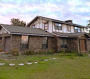 a view of a brick house with a large windows