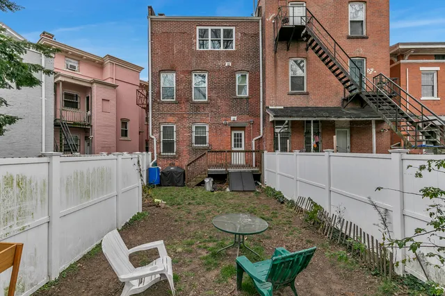 a view of a patio with table and chairs and potted plants
