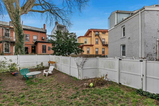 a backyard of a house with table and chairs