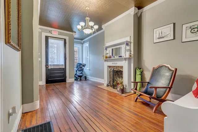 a room with wooden floor fireplace and furniture