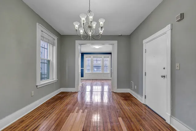 a view of livingroom with chandelier and wooden floor