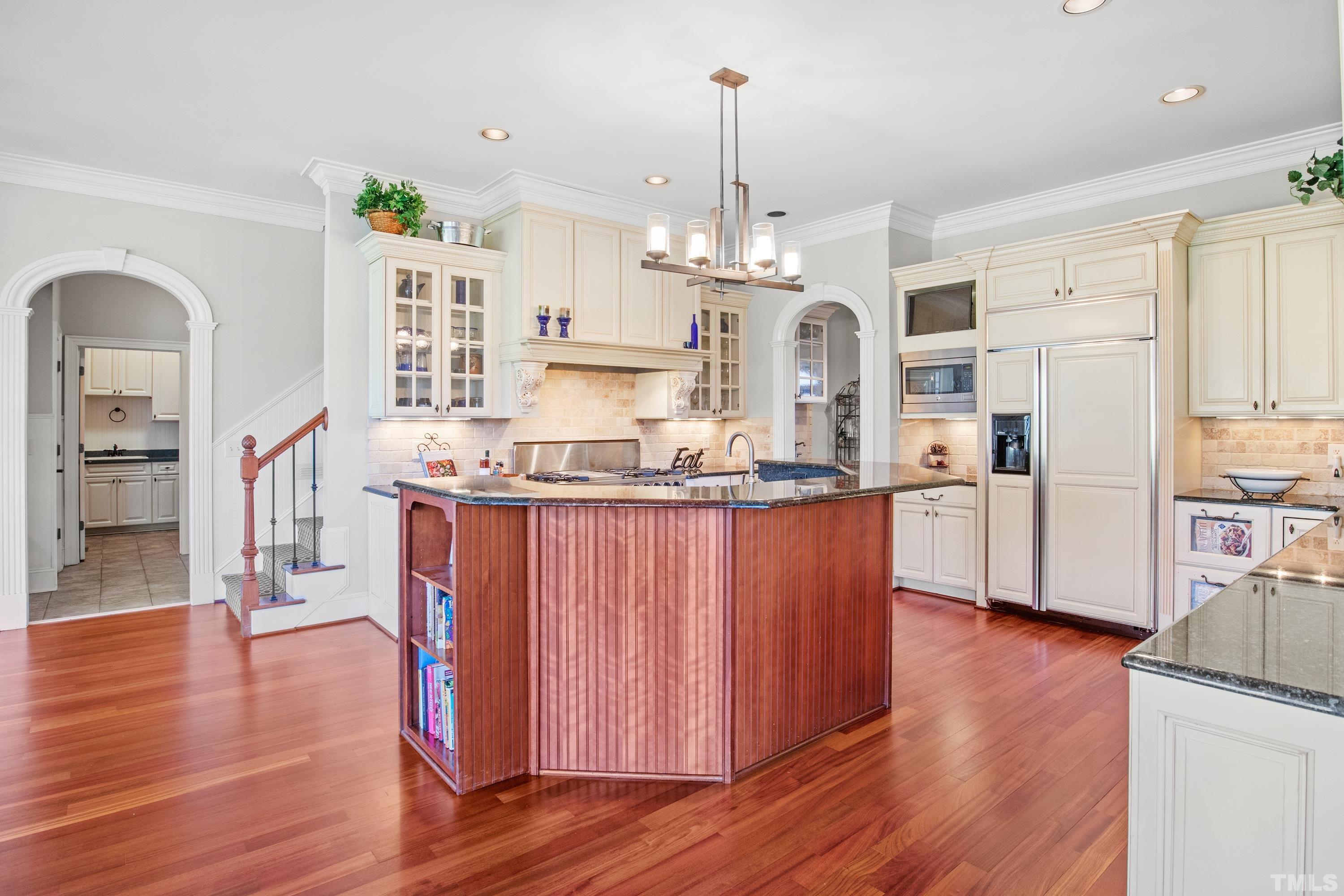 6437 Wakefalls Drive Wake Forest, NC 27587 - Photo 16 of 76 a kitchen with stainless steel appliances granite countertop a refrigerator a oven a stove and a wooden floors