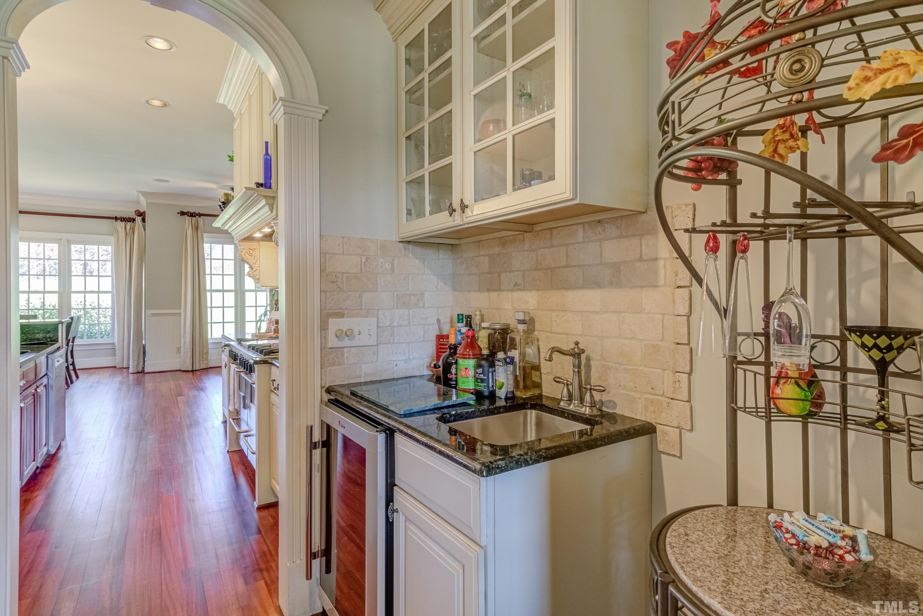 6437 Wakefalls Drive Wake Forest, NC 27587 - Photo 23 of 76 a kitchen with a sink and a wooden floor
