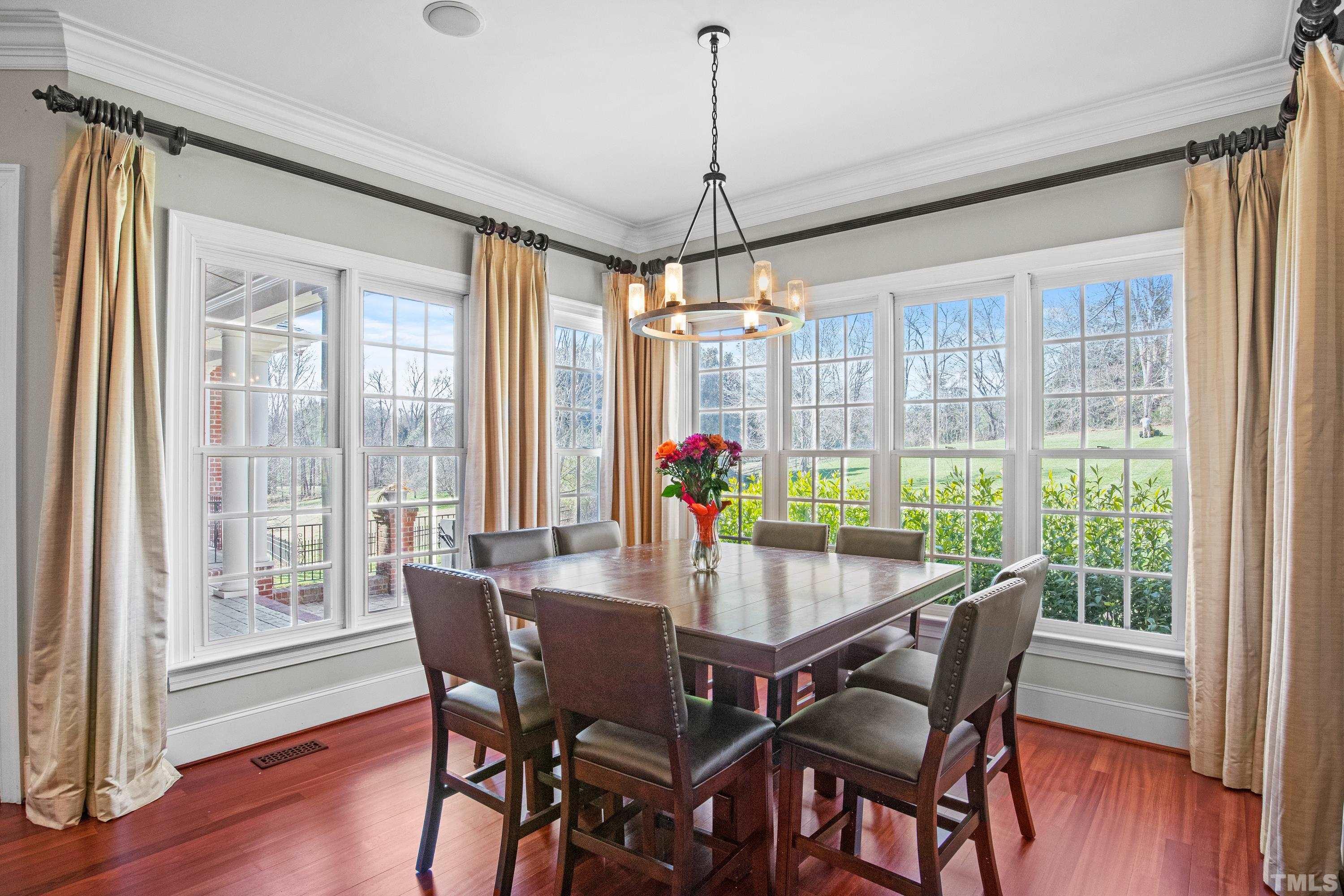6437 Wakefalls Drive Wake Forest, NC 27587 - Photo 24 of 76 a dining room with furniture window and wooden floor