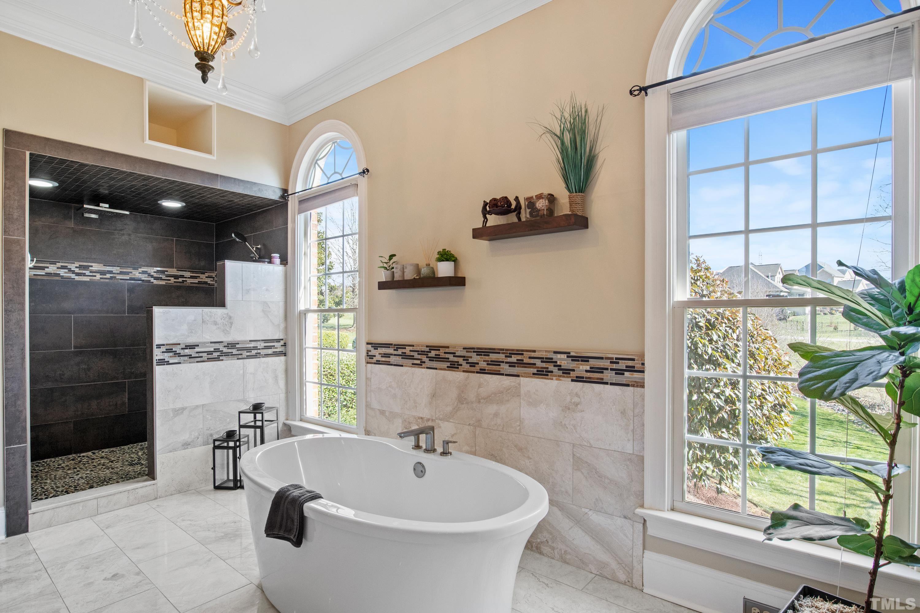 6437 Wakefalls Drive Wake Forest, NC 27587 - Photo 31 of 76 a bathroom with a sink a bathtub and a shower