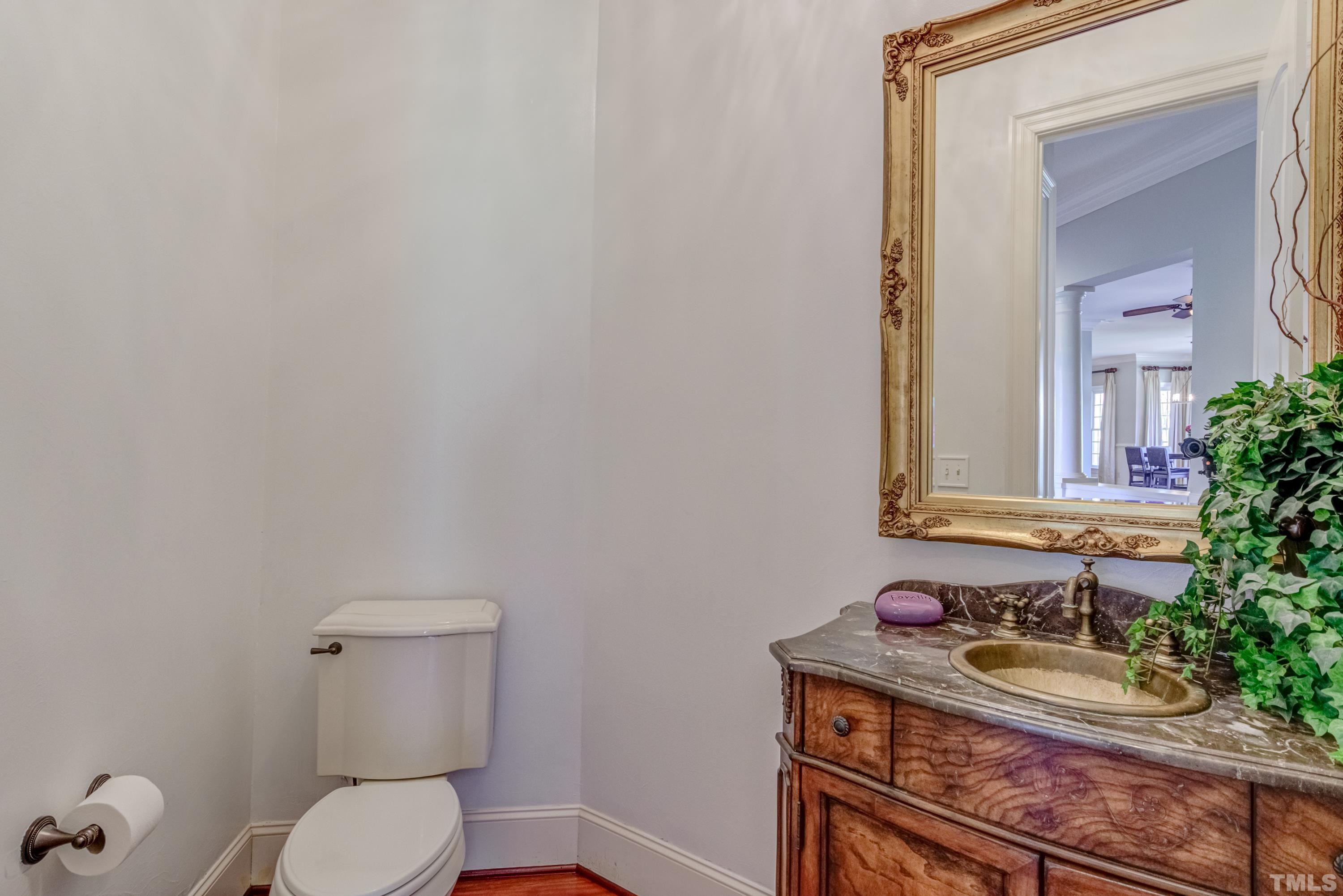 6437 Wakefalls Drive Wake Forest, NC 27587 - Photo 34 of 76 a bathroom with a toilet sink and mirror