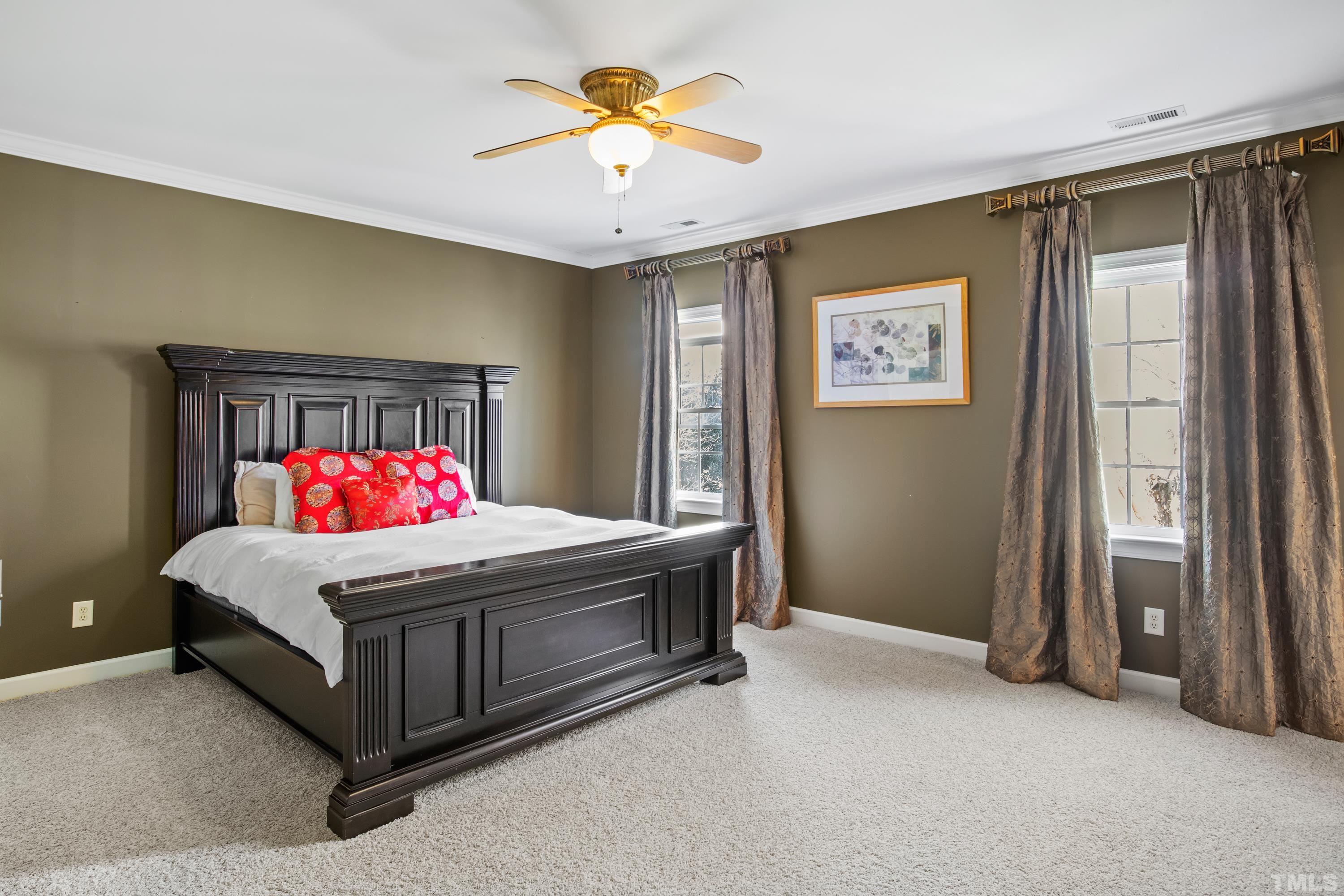 6437 Wakefalls Drive Wake Forest, NC 27587 - Photo 40 of 76 a bedroom with a bed and a chandelier