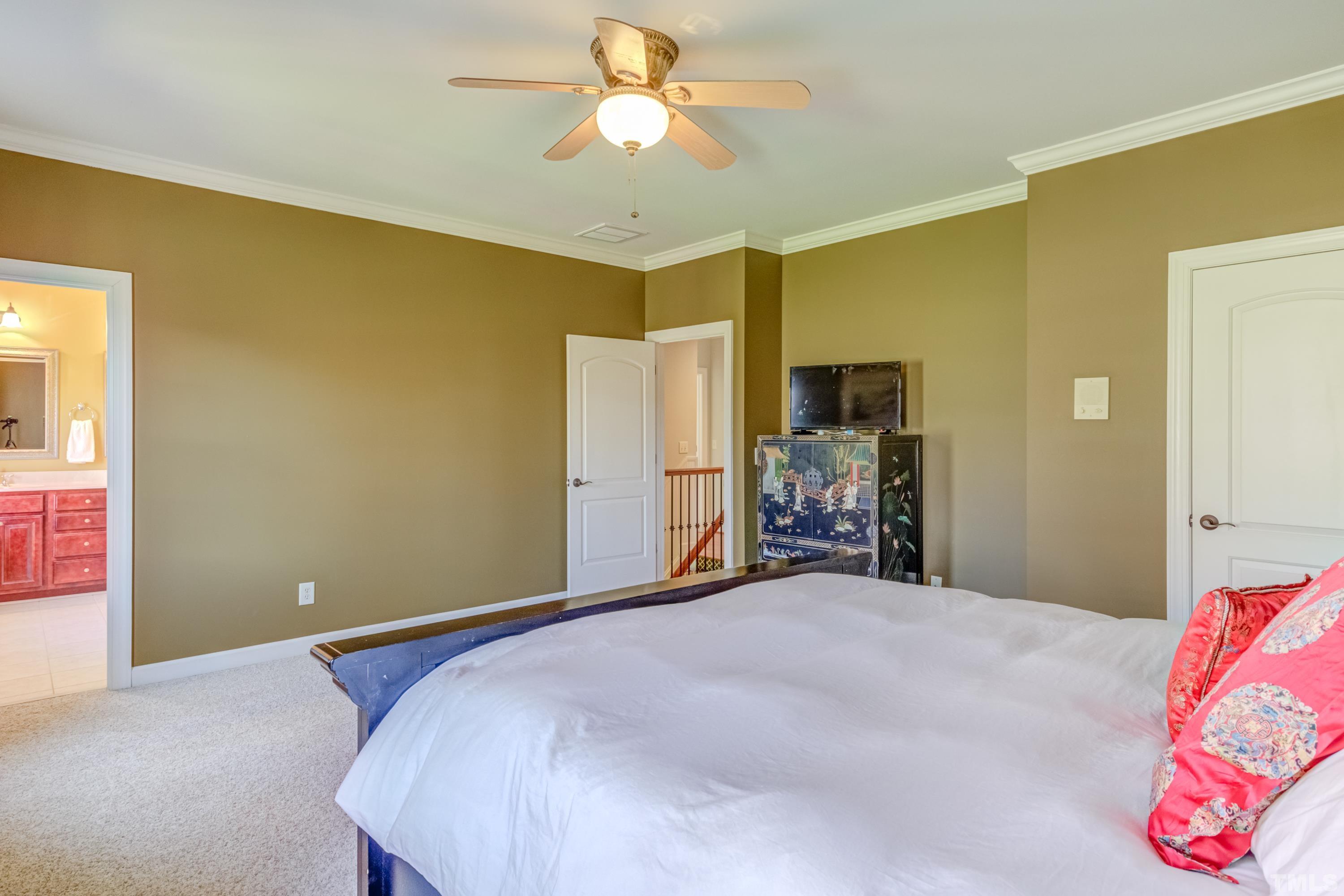 6437 Wakefalls Drive Wake Forest, NC 27587 - Photo 41 of 76 a bedroom with a bed and a chandelier