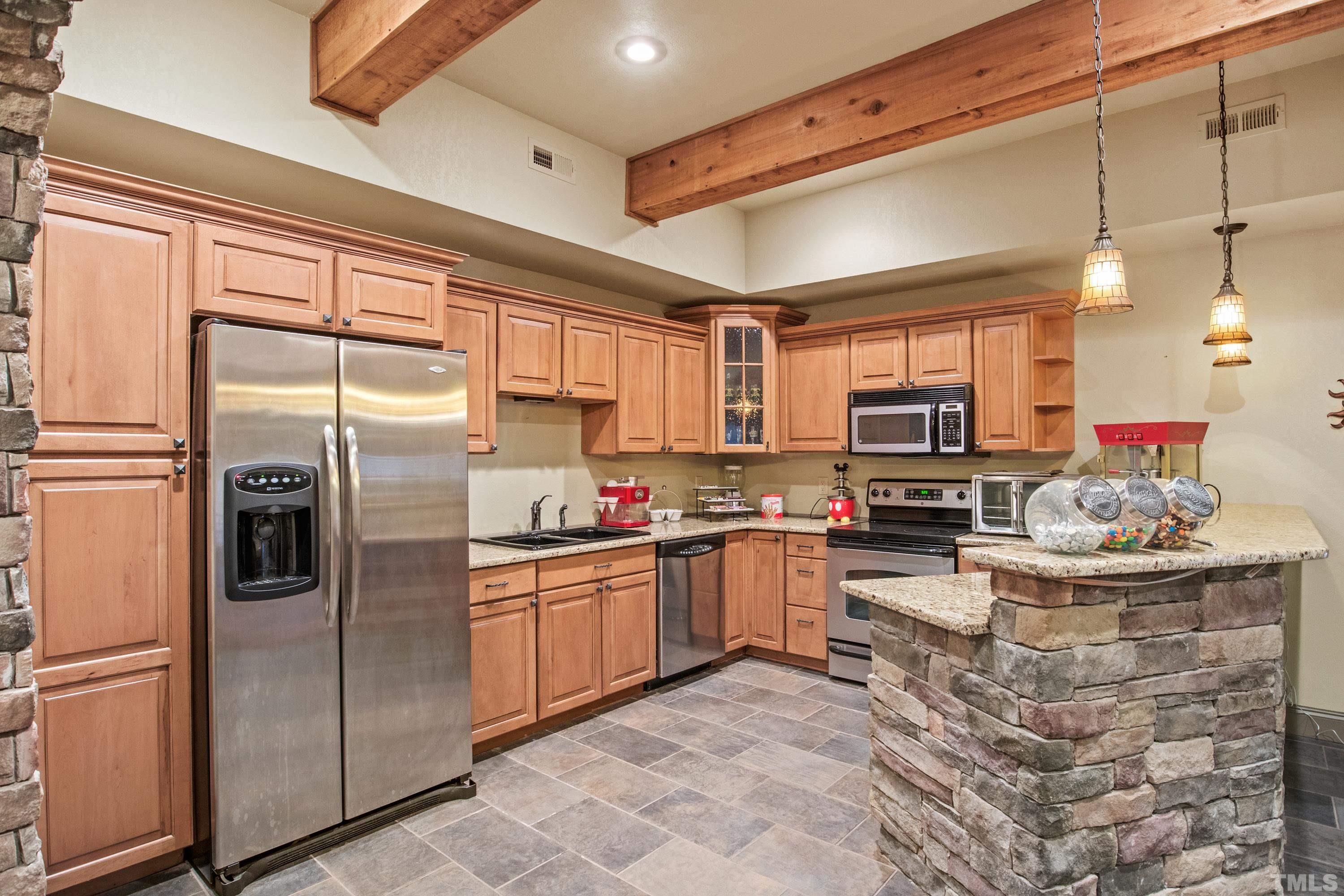 6437 Wakefalls Drive Wake Forest, NC 27587 - Photo 49 of 76 a kitchen with stainless steel appliances kitchen island granite countertop a stove refrigerator and cabinets