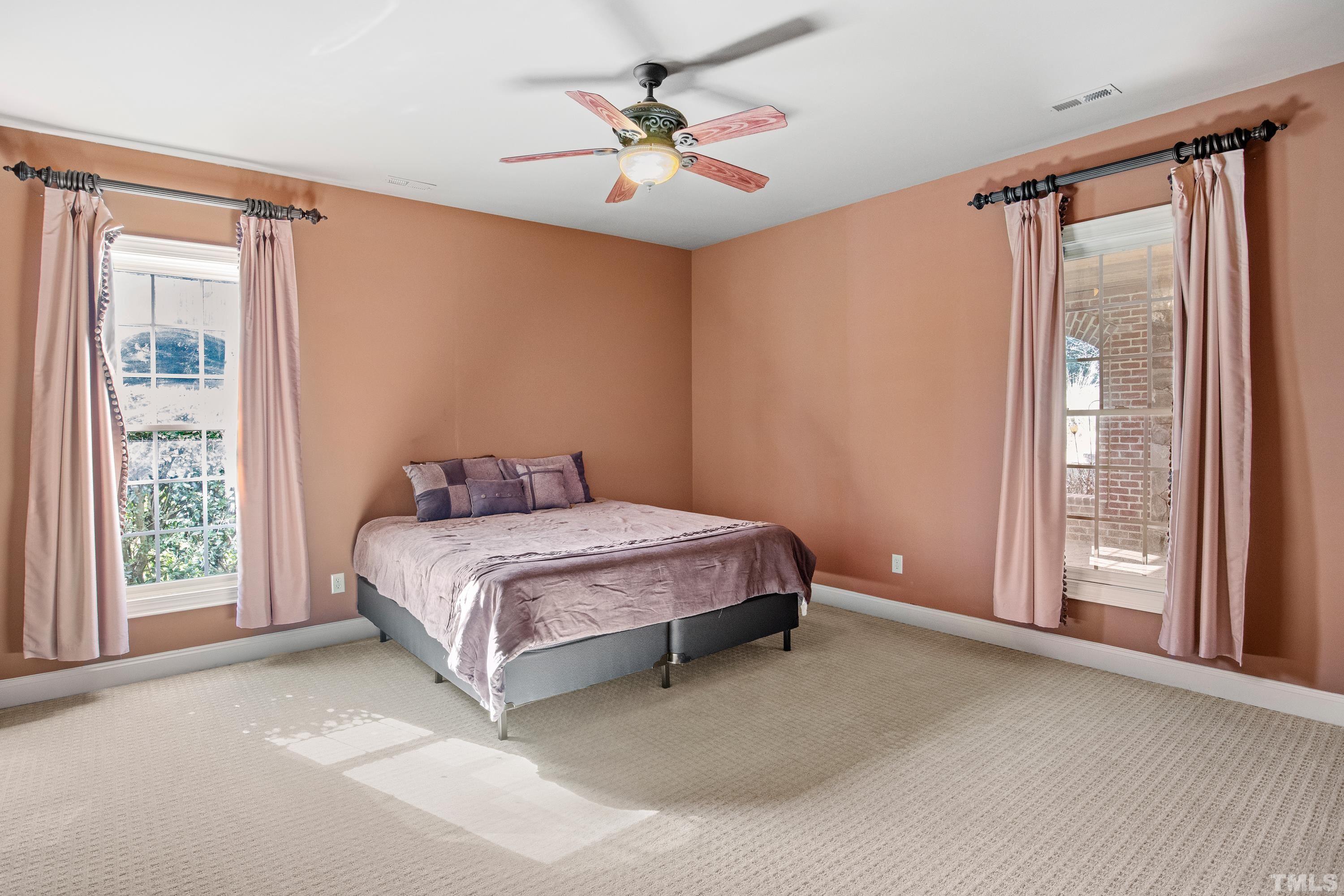 6437 Wakefalls Drive Wake Forest, NC 27587 - Photo 58 of 76 a spacious bedroom with a bed and a window