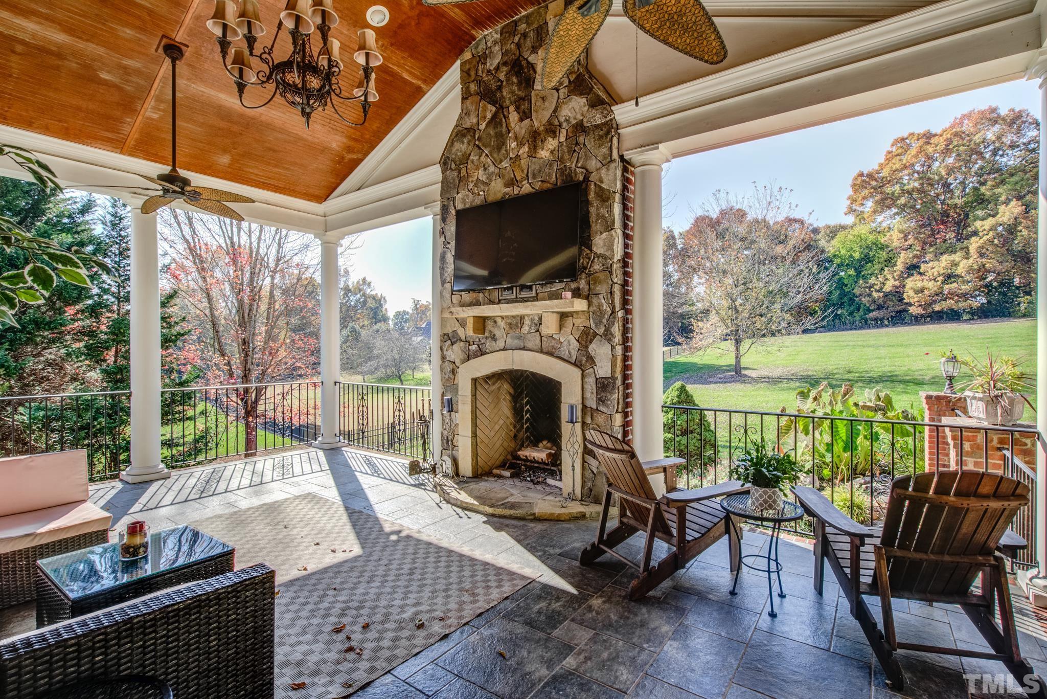 6437 Wakefalls Drive Wake Forest, NC 27587 - Photo 62 of 76 a view of a patio with a table chairs and a grill