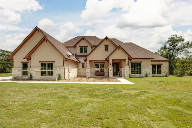 a front view of a house with a yard