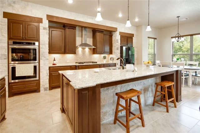 a kitchen with a sink refrigerator and cabinets