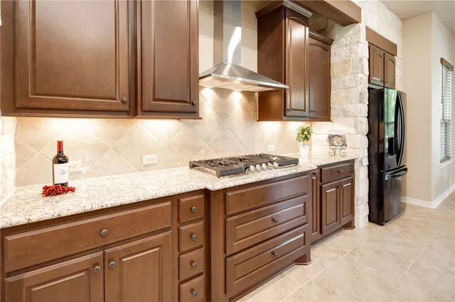 a kitchen with stainless steel appliances granite countertop a sink and a wooden floors