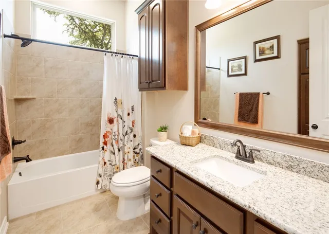 a bedroom with a bed and a lamp next to a window