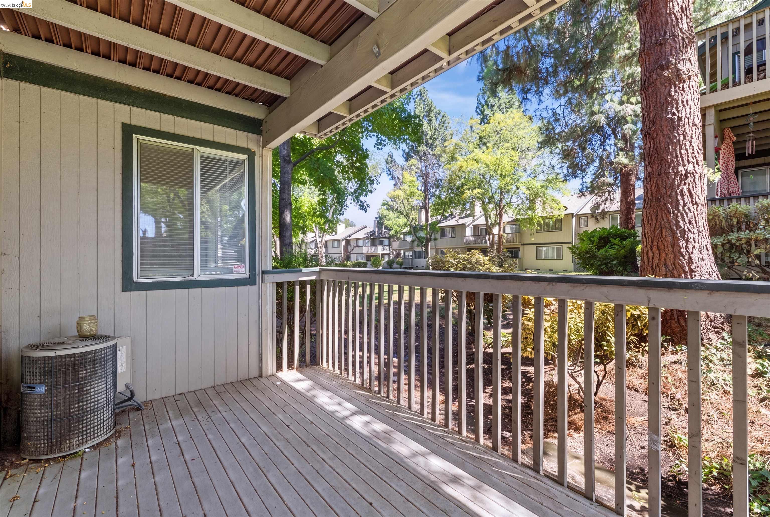 1151 Chadwick Circle Bay Point, CA 94565 - Photo 20 of 23 Outdoor deck featuring natural wood-finish flooring, a wood-slat railing, and a window with blinds