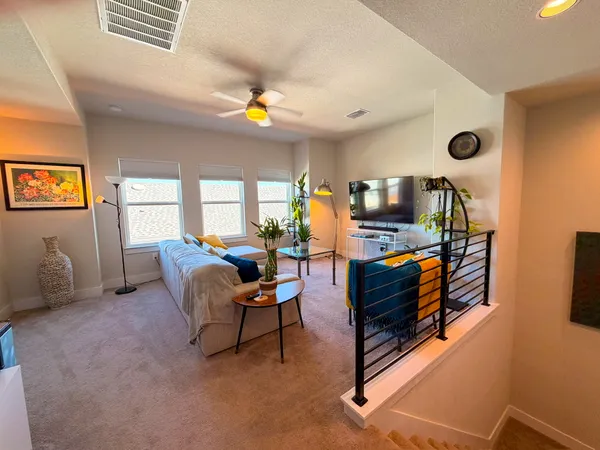 a living room with furniture and a potted plant